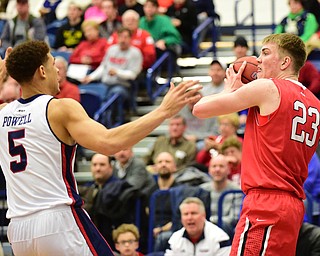 PITTSBURGH, PENNSYLVANIA - MARCH 7, 2015:  Peyton Aldridge #23 of Davidson looks to pass the ball to a teammate while being pressured by TySea Powell #5 of Duquesne during the 1st half of Saturday nights game against Duquesne at the Palumbo Center. (Photo by David Dermer/Youngstown Vindicator)