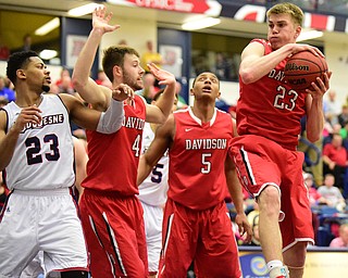 PITTSBURGH, PENNSYLVANIA - MARCH 7, 2015:  Peyton Aldridge #23 of Davidson grabs a rebound away from Tyler Kalinoski #4 and Jordan Barham #5 of Davidson and Jeremiah Stevens #23 of Duquesne during the 2nd half of Saturday nights game against Duquesne at the Palumbo Center. (Photo by David Dermer/Youngstown Vindicator)
