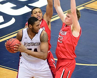 PITTSBURGH, PENNSYLVANIA - MARCH 7, 2015:  Peyton Aldridge #23 and Jordan Barham #5 of Davidson guard Darius Lewis #54 of Duquesne during the 2nd half of Saturday nights game against Duquesne at the Palumbo Center. (Photo by David Dermer/Youngstown Vindicator)