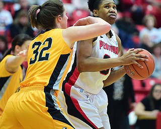 YOUNGSTOWN, OHIO - MARCH 7, 2015: Tisha Walker #32 of YSU looks to the basket while spinning away from Dani Franklin #32 of Valpo during the 1st half of Saturday afternoons NCAA basketball game at Beeghly Center. (Photo by David Dermer/Youngstown Vindicator)