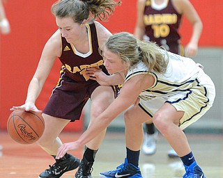 Jeff Lange | The Vindicator  South Range Jordon Youngs (left) maintains possession of the ball as she dribbles past Brookfield's McKenzie Drapola during their sectional final game at Struthers High School.