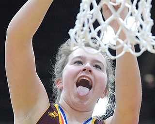 Jeff Lange | The Vindicator  Raiders' Jordon Youngs sticks her tongue out in excitement as she clips a piece of the net down after defeating Brookfield 73 to 43, Saturday afternoon at Struthers High School.