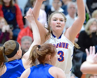 Jeff Lange | The Vindicator  Western Reserve's Aleah Hughes throws a pass over Jackson Milton defenders Kaitlyn Totani (left) and Izzy Scarl (20) during first quarter action of their game, Saturday at Mineral Ridge.