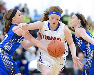 Jeff Lange | The Vindicator  Reserve's Alexis Hughes loses possession of the ball as she drives through Jays' Kaitlyn Totani (left) and Ashley Totani (right) during first half action at Mineral Ridge High School, Saturday afternoon.