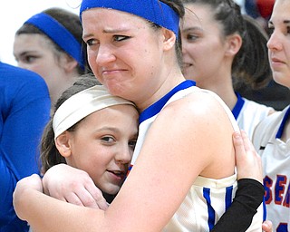 Jeff Lange | The Vindicator  Reserve's Tory White (right) embraces team manager Kennedy Miller (age 11) after the team's victory over Jackson Milton, Saturday at Mineral Ridge.