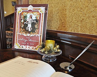 Jeff Lange | The Vindicator  The guest sign-in book and sign found in the foyer of the Sebring Mansion Inn & Spa.