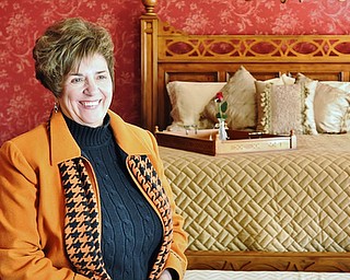 Jeff Lange | The Vindicator  Owner and innkeeper of the Sebring Mansion Inn & Spa, Lynne Biery smiles as she stands in the Sebring Room during a tour of the mansion, Wednesday, February 25, 2015. The Sebring Room is named after the home's original owner Frank Sebring.