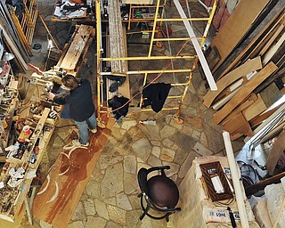 Jeff Lange | The Vindicator  Mike Eddy of Mike Eddy Construction cuts a piece of wood down to size in his makeshift workshop located in the rear of the mansion, Wednesday, February 25, 2015.
