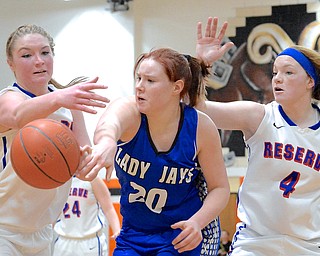 Jeff Lange | The Vindicator  Jackson Milton's Izzy Scarl gets off a pass against Reserve's Aleah Hughes (left) and Alexis Hughes (right) during district final action at Mineral Ridge High School, Saturday.