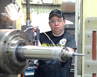 Jeff Lange | The Vindicator  Brian Taggart of East Palestine looks on as he operates a horizontal boring mill, Monday morning at Brilex Industries Inc. in Youngstown.