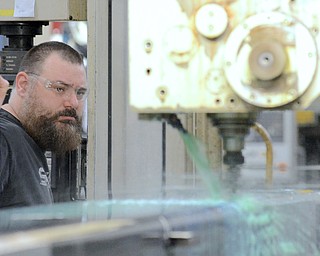 Jeff Lange | The Vindicator  McDonald resident Kevin Baker watches as he runs a horizontal boring machine during work at Brilex Industries Inc. in Youngstown, Monday morning.