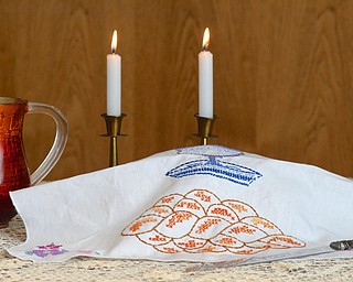 Jeff Lange | The Vindicator  A belcher (left), Shabbat candles and Kiddush cup (right) set around a Challah.
