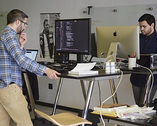 Katie Rickman | The Vindicator.John Mela of Boardman (on left), mobile software engineer for Drund and Adam Magana of Boardman, lead mobile developer work at the Drund office on Thursday, March 5, 2015.