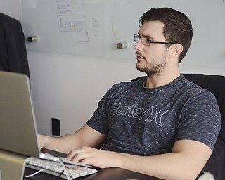 Katie Rickman | The Vindicator.Kevin Kirpicak of Austintown is a software engineer for Drund. He works on his computer at the Drund office on March 5, 2015.