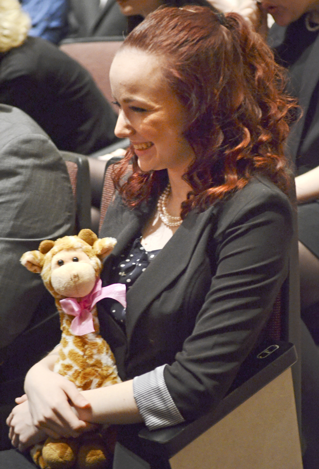 Katie Rickman | The Vindicator.Buffy Wieneke 16, of Middletown Ohio holds a giraffe as she listens to inductees speek during the opening ceremony of the 88th Annual Ohio High School Speech League State Tournament at Boardman High School on Friday, March 6, 2015. Many students carried good luck charms with them.