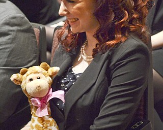 Katie Rickman | The Vindicator.Buffy Wieneke 16, of Middletown Ohio holds a giraffe as she listens to inductees speek during the opening ceremony of the 88th Annual Ohio High School Speech League State Tournament at Boardman High School on Friday, March 6, 2015. Many students carried good luck charms with them.