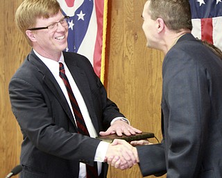 William D. Lewis The Vindicator  Rev Richard Stauffer is sworn in as Austintown TWP trustee 3-6-15 by Probate Judge Robert Rusu Jr.