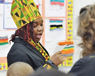 Jeff Lange | The Vindicator  Reading to a group of children and teachers is 11 year old Asia Baker who is presenting her project on Queen Latifah during the 5th grade's Living History Museum held in the lunch room of Williamson Elementary School, Friday morning.