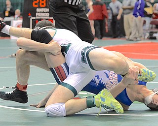 Jeff Lange | The Vindicator  Austintown's Adam Green (right) grabs the leg of Mason's Nick D'Agostino during their Division I 152 pound matchup in Columbus as part of the state wrestling tournament, Thursday afternoon.