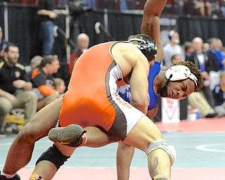 Jeff Lange | The Vindicator  170 pound wrestler from Austintown Isiah Jackson (right) is slammed to the mat by Mansfield's Jesse Palser during their Division I bout Thursday afternoon during state tournament preliminaries in Columbus.