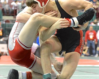 Jeff Lange | The Vindicator  Canfield's Georgio Paullas (right) grabs the leg of opponent Andrew Murphy of Dover as he takes him down during their 126 pound Division II matchup at the state wrestling meet in Columbus, Thursday afternoon.
