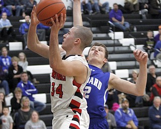 Canfields #34 Vince Leone drives by Hubbards #12  Derek Kopanic -  as he goes for two in the first quarter. .ROBERT  K. YOSAY | THE VINDICATOR