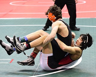 COLUMBUS, OHIO - MARCH 14, 2015: Matthew Cardello of Canfield takes down Eric Bartos of Medina Buckeye during their 106lb Division 2 consolation round bout Saturday morning at Schottenstein Center. (Photo by David Dermer/Youngstown Vindicator)