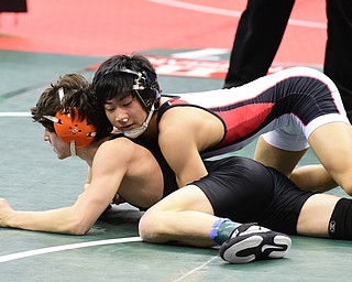 COLUMBUS, OHIO - MARCH 14, 2015: Matthew Cardello of Canfield controls the back of Eric Bartos of Medina Buckeye during their 106lb Division 2 consolation round bout Saturday morning at Schottenstein Center. (Photo by David Dermer/Youngstown Vindicator)