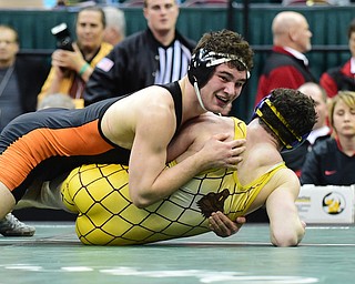 COLUMBUS, OHIO - MARCH 14, 2015: David-Brian Whisler of Howland smiles while watching the clock tick to zero while laying onto of Benjamin Schram of Bellbrook during their 170lb Division 2 championship round bout Saturday night at Schottenstein Center. (Photo by David Dermer/Youngstown Vindicator)