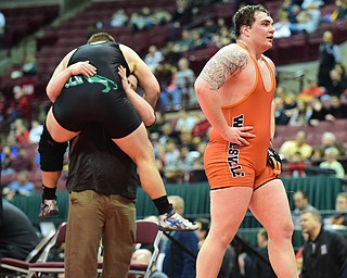 COLUMBUS, OHIO - MARCH 14, 2015: Seth Bloor of Wellsville walks to his corner while Chance Veller of Delta leaps into the arms of his coaches after their 285lb Division 3 championship round bout Saturday night at Schottenstein Center. (Photo by David Dermer/Youngstown Vindicator)