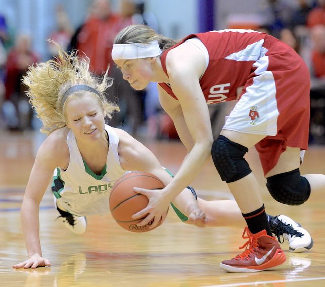 Jeff Lange | The Vindicator  West Branch's Melinda Trimmer (left) dives to the floor in attempt to steal the ball away from Geneva's Kristin Keasling in the third quarter of the Lady Warriors Division II regional final held at Barberton High School, Saturday afternoon. West Branch topped Geneva 50-30.