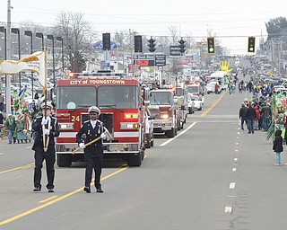 Katie Rickman | The Vindicator.Youngstown Professional Firefighters lead the way for the fire trucks during the St. Patrick's Day Parade in Boardman Sunday March 15, 2015.