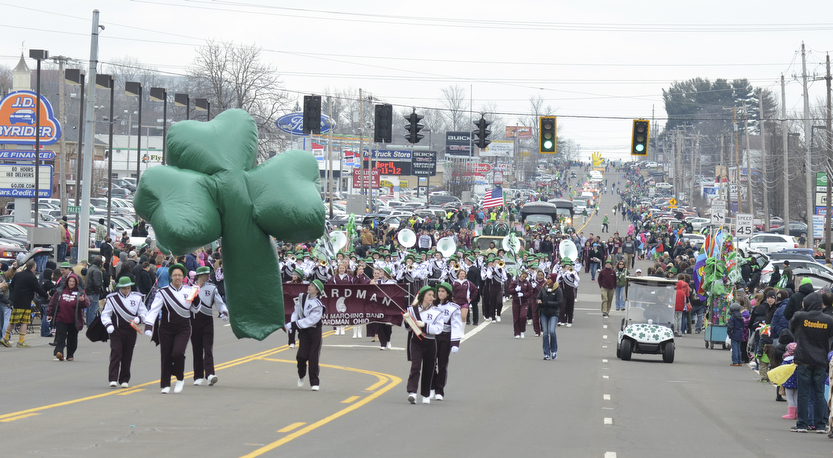 Katie Rickman | The Vindicator.The Boardman High School marching band carries  shamrock balloon as the marching band follows closely behind during the St. Patrick's Day Parade in Boardman on March 15, 2015.