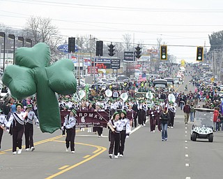 Katie Rickman | The Vindicator.The Boardman High School marching band carries  shamrock balloon as the marching band follows closely behind during the St. Patrick's Day Parade in Boardman on March 15, 2015.