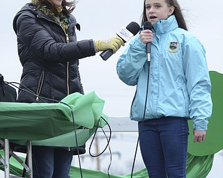 Katie Rickman | The Vindicator.Gemma Kearns, originally from Ireland but currently residing in Struthers,  sings the Irish National Anthem in Gaelic as the St. Patrick's Day Parade kicked off in Boardman on March 15, 2015. Casey Malone holds the mic up for her.