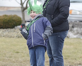 Katie Rickman | The Vindicator.Ryan Bulford 7 of Leetonia motions for a parade participant to honk its horn as it passes by, his mother Christina stand behind him watching the parade pass on March 15, 2015.