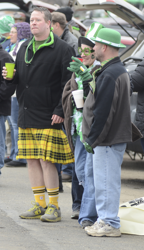 Katie Rickman | The Vindicator.Mike Hurl of Boardman (left) dances as the bagpipers pass by, his friends Denise Hetrick of Canfield and Lee Wolfe of North Jackson enjoy the parade in their St. Patrick's Day apparel on March 15, 2015.