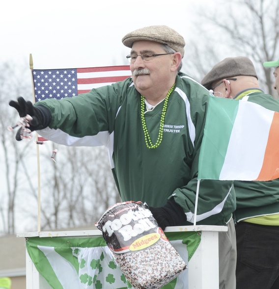 Katie Rickman | The Vindicator.Tom Costello a Boardman Trustee throws candy out from the Boardman Trustees float during the St. Patrick's Day Parade in Boardman on March 15, 2015.