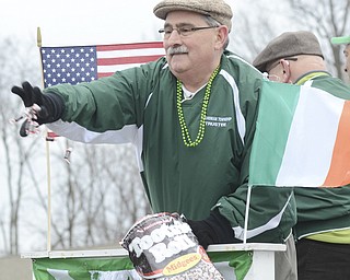 Katie Rickman | The Vindicator.Tom Costello a Boardman Trustee throws candy out from the Boardman Trustees float during the St. Patrick's Day Parade in Boardman on March 15, 2015.