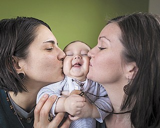 Kelly McCracken, 32, her wife Kelly Noe, 32, pose with their daughter Ruby Noe-McCracken, 7 months, at their home in the Cincinnati area, on Sunday, Jan. 11, 2015. McCracken and Noe were married in 2011 in  Provincetown, Massachusetts. (Sam Greene/SGdoesit.com for Lambda Legal)