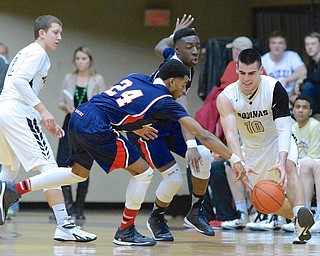 Jeff Lange | The Vindicator  Kennedy's A.J. Grant (24) and James Burney (back) knock the ball away from Aquinas' Anthony Moeglin (10) as Logan Newman looks on from the left during fourth quarter action at Canton Fieldhouse, Tuesday night.