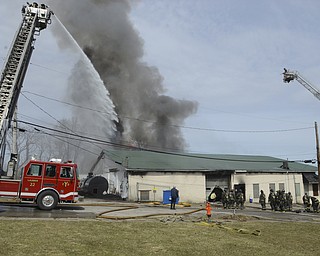 Katie Rickman | The Vindicator.Youngstown Firefighters attempt to put out the fire at Asphalt Solutions on Market Street on March 19, 2015.