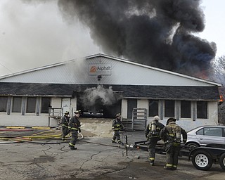Katie Rickman | The Vindicator.Youngstown Firefighters work to put out a fire at Asphalt Solutions on March 19, 2015.