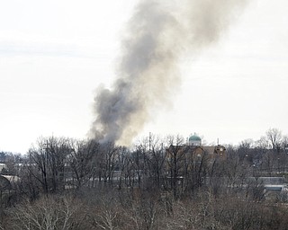 Katie Rickman | The Vindicator.Smoke rises from  Asphalt Solutions on Market Street, it was reported that the smoke could be seen from miles away-as seen here from the roof of the Vindicator on March 19, 2015.
