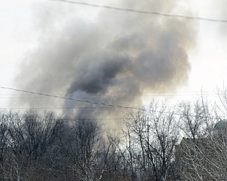 Katie Rickman | The Vindicator.Smoke rises from  Asphalt Solutions on Market Street, it was reported that the smoke could be seen from miles away-as seen here from West Front Street on March 19, 2015.