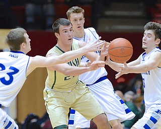 Jeff Lange | The Vindicator  St. Vincent - St. Mary's Niko Lalos (center) throws the ball away as he is pressured by Poland's Jared Burkert (left) and Nick Gajdos (right) in the third quarter of their Division II regional semifinal game in Canton, Thursday night.
