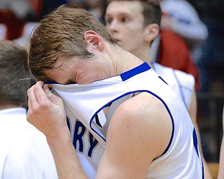 Jeff Lange | The Vindicator  Poland's Kyle Dixon wipes the sweat and tears from his face after losing to Akron 67 to 44 in the regional semifinal, Thursday night in Canton.
