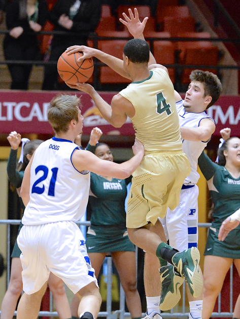 Jeff Lange | The Vindicator  Poland's Kyle Dixon (left) and Nick Gajdos (right) attempt to block the shot of St. V's Josh Williams in the second half of their regional semifinal, Thursday night in Canton.