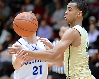 Jeff Lange | The Vindicator  Poland's Kyle Dixon (21) loses possession of the ball as he is pressured by St. Vincent - St. Mary's Josh Williams in the third period of their Division II regional semifinal matchup, Thursday night in Canton. Poland lost to St. V 67 to 44.