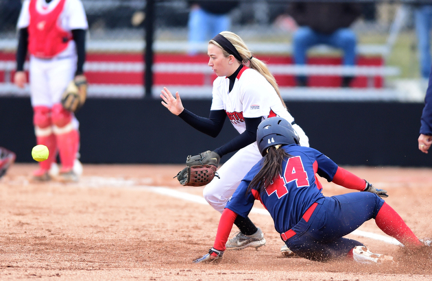 YOUNGSTOWN, OHIO - MARCH 20, 2015: Third-basemen Stevie Taylor #6 of YSU fields the ball while Savanna Ferstle #44 of Detroit slides into third to advance on a tag up in the top of the 4th inning during Friday evenings game at the YSU Softball Complex.(Photo by David Dermer/Youngstown Vindicator)